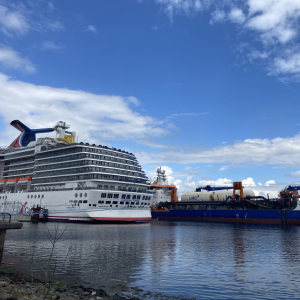 A white cruise ship in Inverclyde sits on a brown river